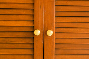 Texture of wooden doors with golden knobs
