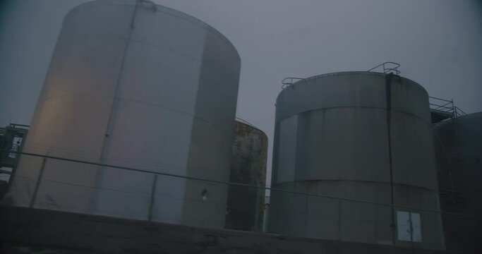 Montreal, QC, Canada - November 15 , 2017: Worm eye view of Oil refineries storage tanks, filmed while driving near Montreal East Refinery.