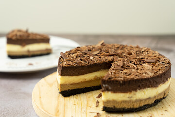 Homemade triple layers chocolate bake cheesecake in round shape
