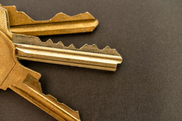 Gold color door keys on a gray table