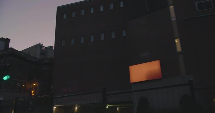 Montreal, QC, Canada - April 15, 2017: Worm Eye View Of Percival Molson Memorial Stadium, Dusk Sky In Background, Filmed While Driving On Pine Avenue.