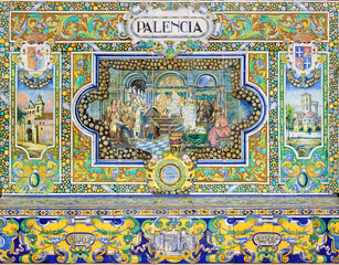 Image with the name of the spanish city of Palencia and a historical scene painted on ceramic tiles - seating benches in Spain Square in Seville