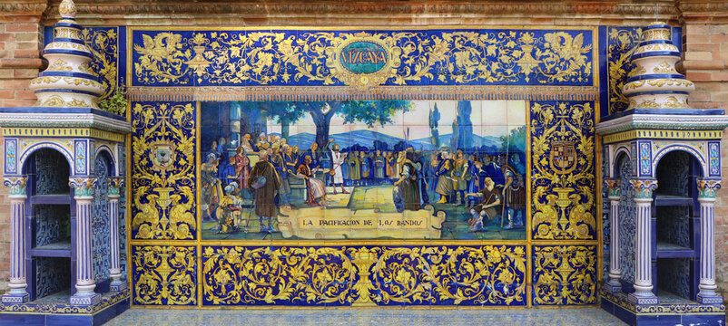 Image with the name of the spanish city of Vizcaya and a historical scene painted on ceramic tiles - seating benches in Spain Square in Seville