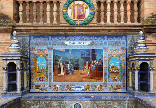 Image with the name of the spanish city of Zaragoza painted on ceramic tiles and the emblem shield - seating benches in Spain Square in Seville