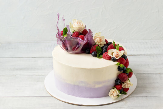 Cake with roses, fresh berries and isomalt vase. Birthday cake.