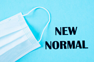 NEW NORMAL word with surgical medical face mask.