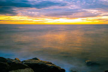 Long exposure seascape with silky smooth water at sunset