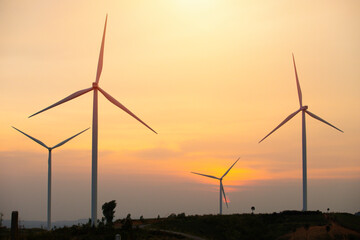 Wind turbine during sunrise or sunset,wind turbines silhouette on mountain,Beautiful sunsets with wind power generators