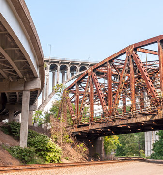 Railroad tracks under three bridges, an old rusted railroad bridge, the Braddock Avenue overpass and the East Pittsburgh bridge that US Route 30 runs upon