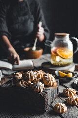 Woman cooks in a vintage kitchen on wooden tablet. Healthy drink, Eco, vegan.