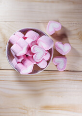 Marshmallows heart on wood background in vintage tone