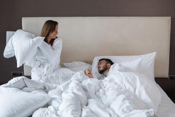 Fototapeta premium Young cute couple, man and woman in bed.