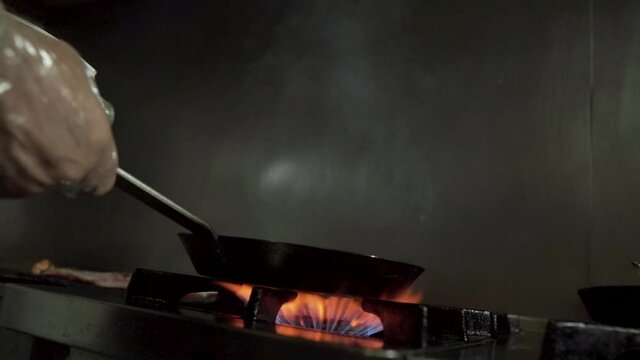 Chef cooking with fire in the kitchen! slow moHD