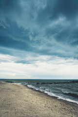 Storming sea with dark clouds in the autumn's morning. Sea landscape.