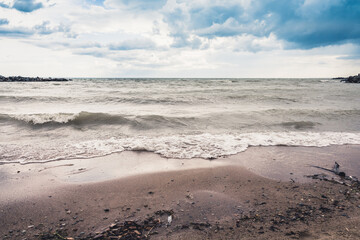 Storming sea with dark clouds in the autumn's morning. Sea landscape.