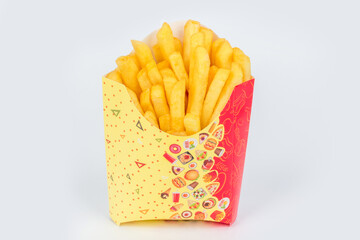 French fries in colored packaging shot on a white background