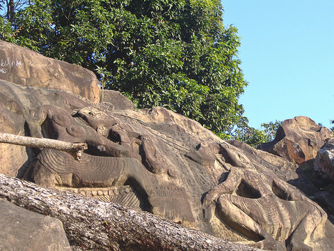 Mysterious sculptured figures on a stone wall at a disclosed location, Tripura, India.