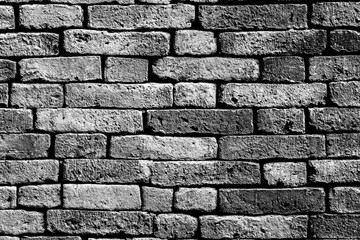 The Black and white photo of the background of the old brick wall surface is strong, resistant to rain, and sun.