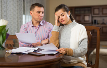 Portrait of couple filling out financial documents at home