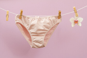 Beautiful women cotton panties on lilac background.