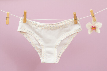 Beautiful women cotton panties on lilac background.