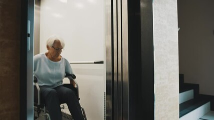 elderly disabled woman using the lift in the wheelchair. Slow motion. High quality 4k footage