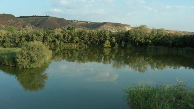 Aerial shot of forest in the Pic&oacute;n de los Conejos and its reflections on a lake.