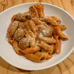 Red creamy pasta with meatballs.