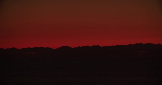 Timelapse of amazing orange red sunset at sea with grey clouds above horizon