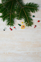 Christmas background with copy space for text and design. Fir branch and wooden christmas toys