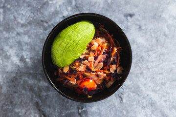 plant-based food, vegan salad bowl with teriyaki sauce salad mix almonds and avocado