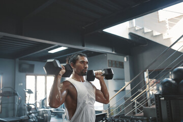 Man Workout With Dumbbells At Gym. Asian Sportsman On Intense Training At Fitness Center. Sexy Guy...