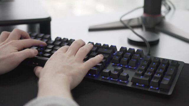 Man typing on computer keyboard