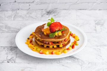 delicious pancakes on marble table with fruits