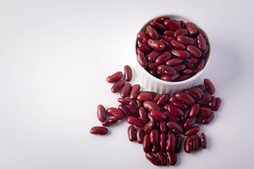 Red beans in a white ceramic cup on a white background