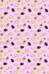 Avocado. Background made from isolated Avocado pieces on pink background. Flat lay of fresh ripe avocados and avacado pieces.