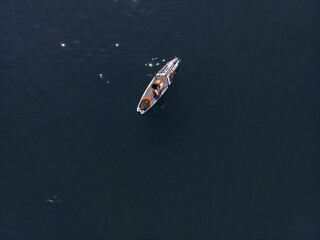 Attractive Woman on Stand Up Paddle Board, Woman paddling on sup board and enjoying turquoise transparent water. Tropical travel, wanderlust and water activity concept. Sunset and relax