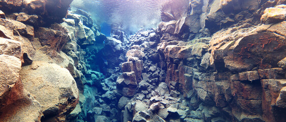 beautiful clear glacial water from Icelandic spring known as Silfra filling canyon