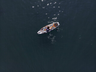Attractive Woman on Stand Up Paddle Board, Woman paddling on sup board and enjoying turquoise transparent water. Tropical travel, wanderlust and water activity concept. Sunset and relax