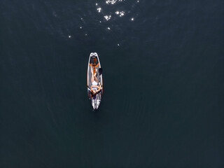 Attractive Woman on Stand Up Paddle Board, Woman paddling on sup board and enjoying turquoise...