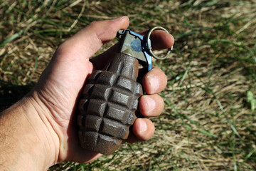 American combat grenade in a man's hand