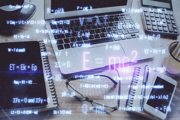 Desktop computer background and formula hologram writing. Double exposure. Education concept.