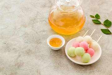 Japanese tea and sweet dumplings Dango on plate, close up