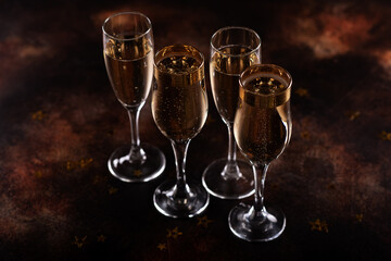 selective focus of glasses full of champagne against christmas lights.