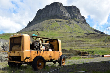 abandoned construction machinery against rocky hill backdrop in iceland