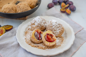 Typical Austrian plum dumplings made of leavened dough and fresh plums