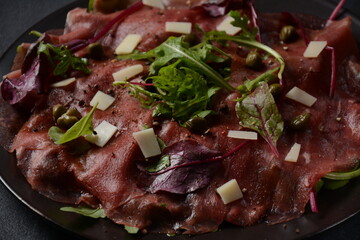 Beef Carpaccio  with parmesan, capers and arugula. With olive oil and soy sauce