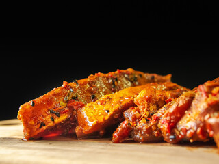 Fresh uncooked pork belly slices on a wooden board, Meat marinated in Korean style marinate. Meat industry product.