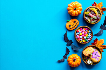 Overhead view of Halloween holiday decoration with pumpkins, cookies and candies