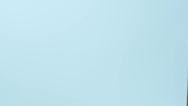 Man taking paper cup and paying to courier with credit card on blue background